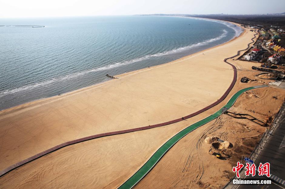 3月13日，秦皇島萬(wàn)米臨海沙灘木棧道。據(jù)了解，該木棧道全長(zhǎng)約4200米，與北戴河區(qū)原有的7500米木棧道對(duì)接后全線(xiàn)總長(zhǎng)度1.17萬(wàn)米，整個(gè)木棧道東起秦皇島體育基地游船碼頭，西至北戴河濕地公園，呈波浪形蜿蜒10.4公里海岸線(xiàn)。 中新社發(fā) 曹建雄 攝 CNSPHOTO